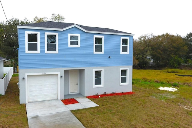 view of front of property with a garage and a front yard