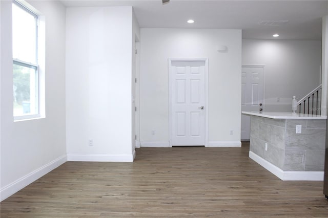 empty room with dark hardwood / wood-style flooring