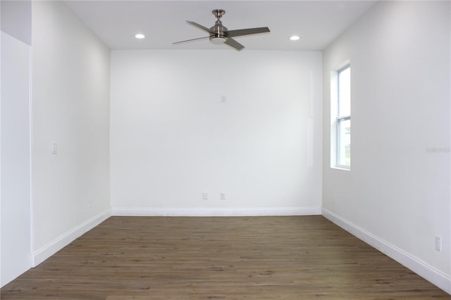 spare room with ceiling fan, dark hardwood / wood-style floors, and a healthy amount of sunlight