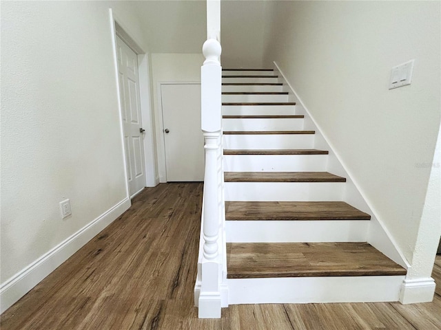 stairs featuring wood-type flooring