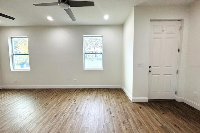 unfurnished room with hardwood / wood-style flooring and ceiling fan