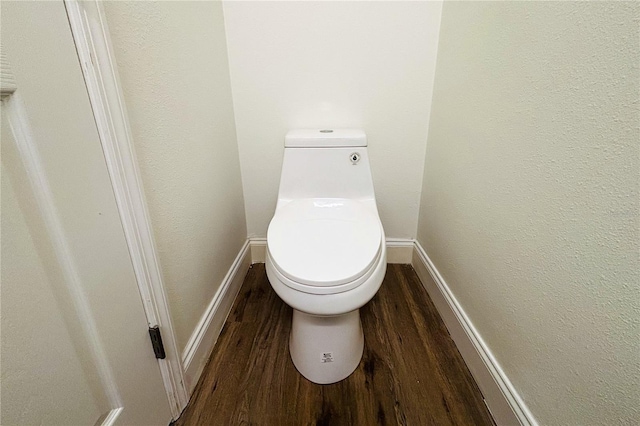 bathroom featuring wood-type flooring and toilet