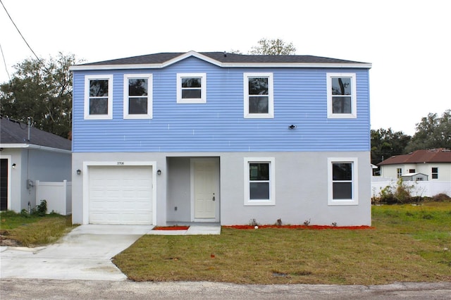 view of front of property featuring a garage, a front yard, and stucco siding