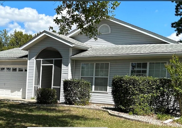 view of front facade with a garage and a front lawn