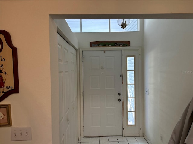 foyer entrance with light tile flooring