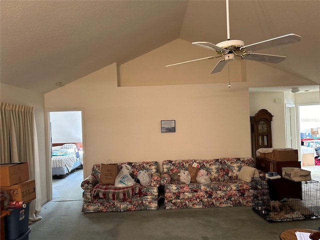 carpeted living room with high vaulted ceiling and ceiling fan