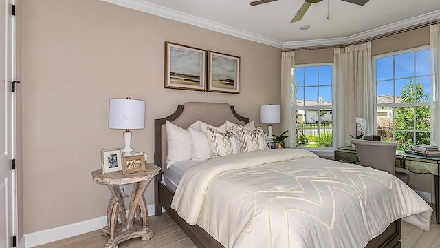 bedroom with ornamental molding, ceiling fan, and light wood-type flooring