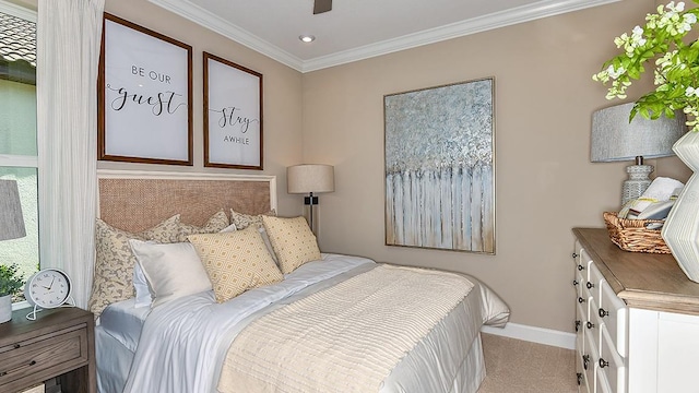 carpeted bedroom with ceiling fan and ornamental molding