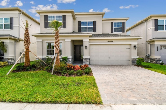 view of front of house featuring a front lawn and a garage