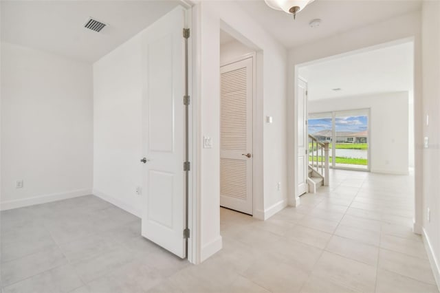 corridor with light tile floors