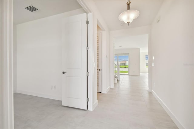 hall featuring light tile flooring