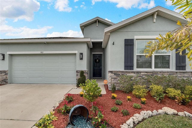 ranch-style house featuring stone siding, an attached garage, and stucco siding