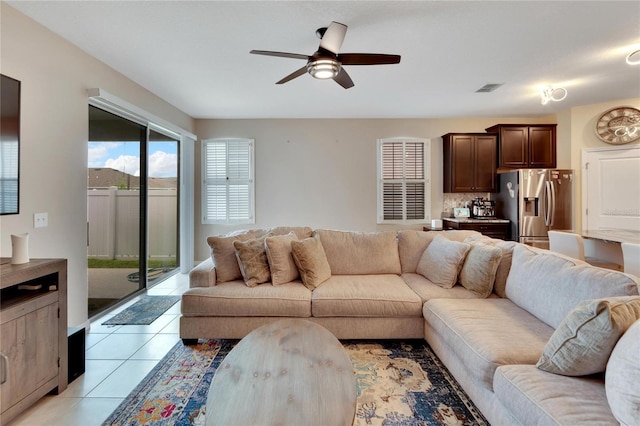 living area with ceiling fan, visible vents, and light tile patterned flooring