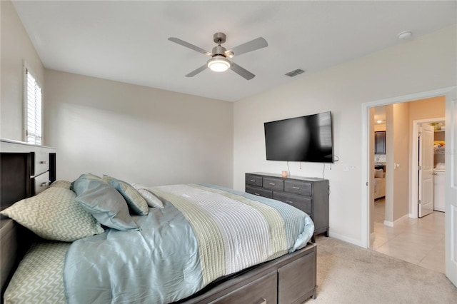 bedroom featuring light tile patterned flooring, light carpet, visible vents, baseboards, and a ceiling fan