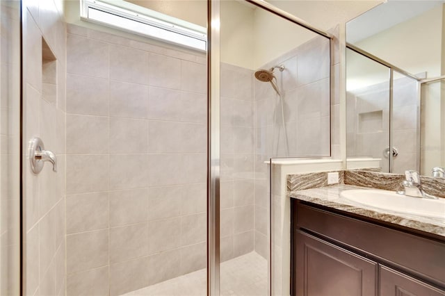 bathroom featuring a shower stall and vanity