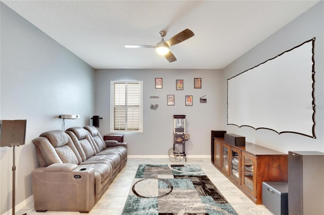 living area with ceiling fan, light wood-type flooring, and baseboards