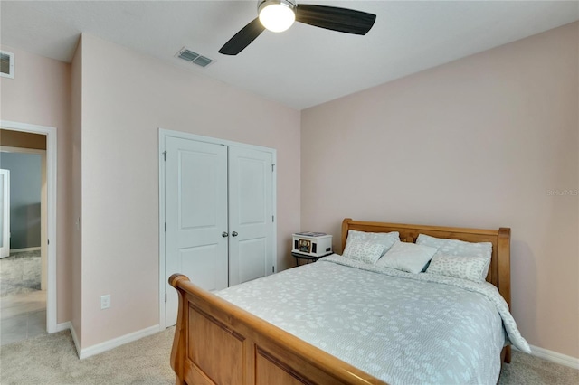 bedroom featuring light carpet, baseboards, visible vents, and ceiling fan