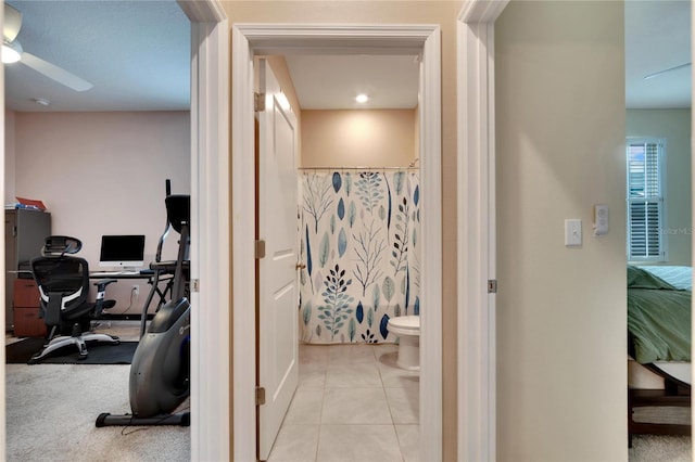 home office featuring light tile patterned floors and ceiling fan