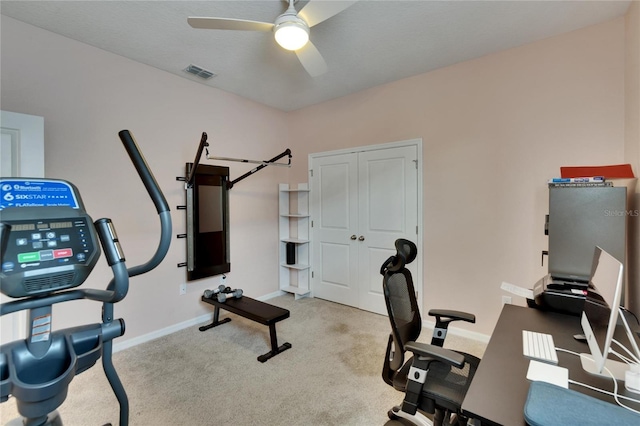 office featuring light carpet, baseboards, visible vents, and a ceiling fan