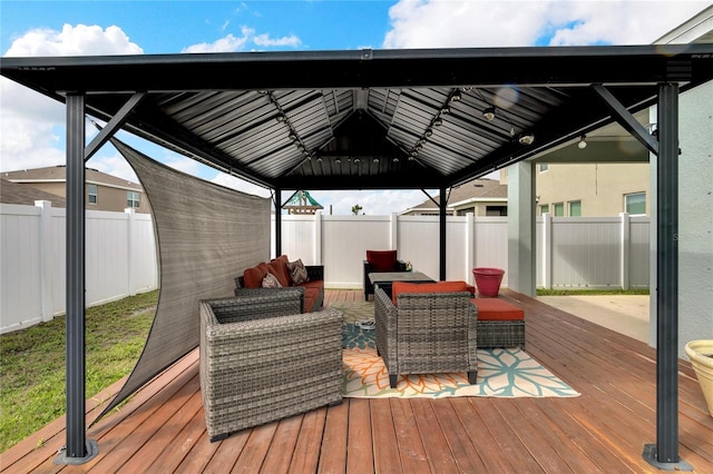 wooden terrace with a gazebo, a fenced backyard, and an outdoor living space