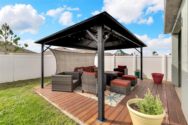 wooden deck featuring an outdoor hangout area, a gazebo, a yard, and a fenced backyard