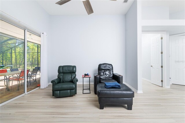 sitting room featuring ceiling fan and light wood-type flooring