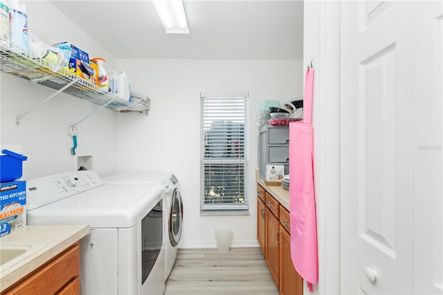 laundry area featuring washer hookup, washer and dryer, and light wood-type flooring