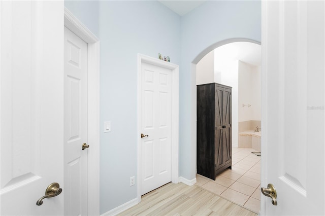 hall featuring light tile floors