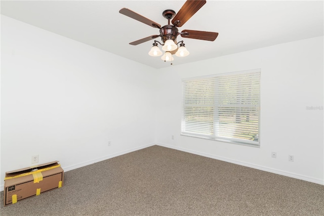 carpeted spare room featuring ceiling fan