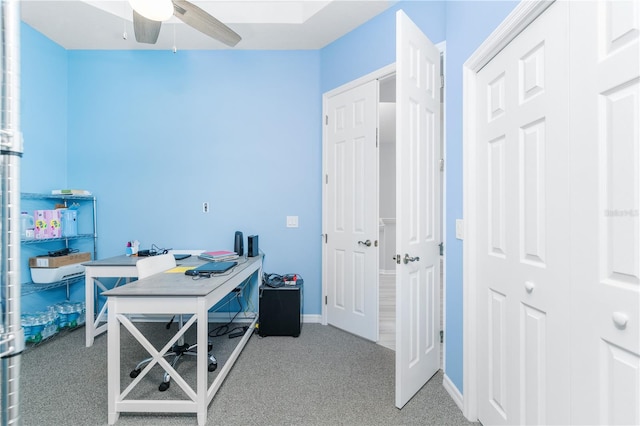 office area featuring light carpet and ceiling fan