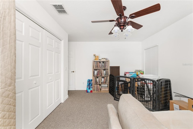 interior space featuring light carpet and ceiling fan