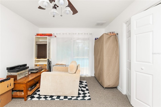 home office with light carpet and ceiling fan with notable chandelier