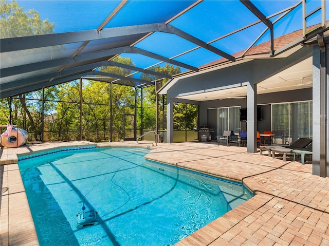 view of pool featuring a patio area and glass enclosure