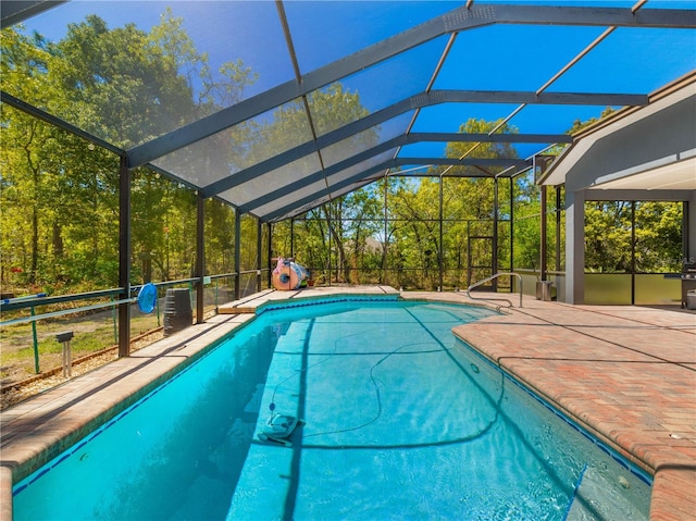 view of swimming pool featuring a patio area and glass enclosure