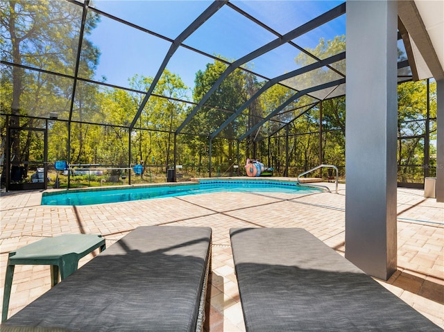 view of swimming pool with a lanai and a patio