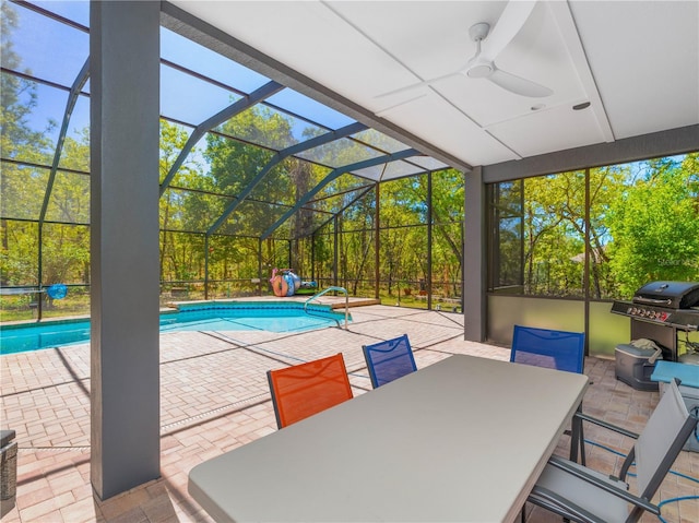 view of pool featuring ceiling fan, a patio area, grilling area, and glass enclosure