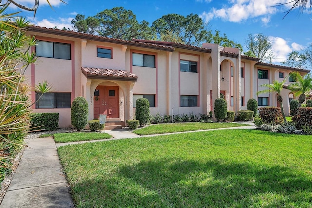 mediterranean / spanish home with a front yard