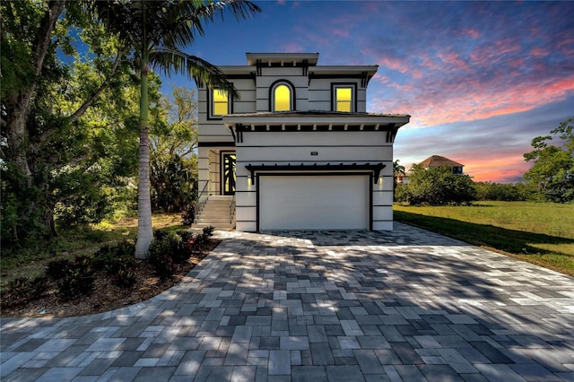 view of front of home featuring a yard and a garage