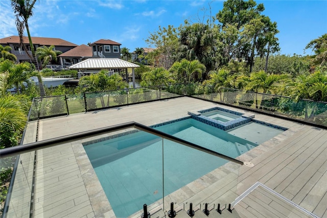 view of swimming pool with an in ground hot tub and a gazebo