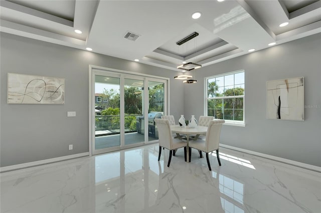 dining area featuring a tray ceiling and light tile floors