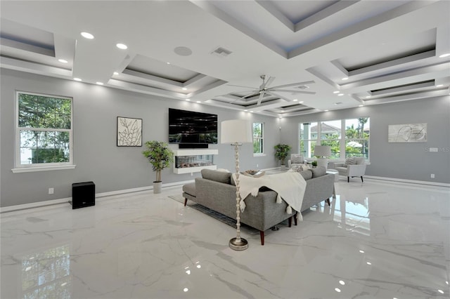 living room with a healthy amount of sunlight, ceiling fan, light tile flooring, and coffered ceiling