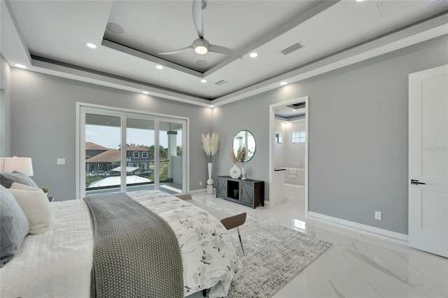 tiled bedroom with ensuite bath, ceiling fan, access to outside, and a tray ceiling