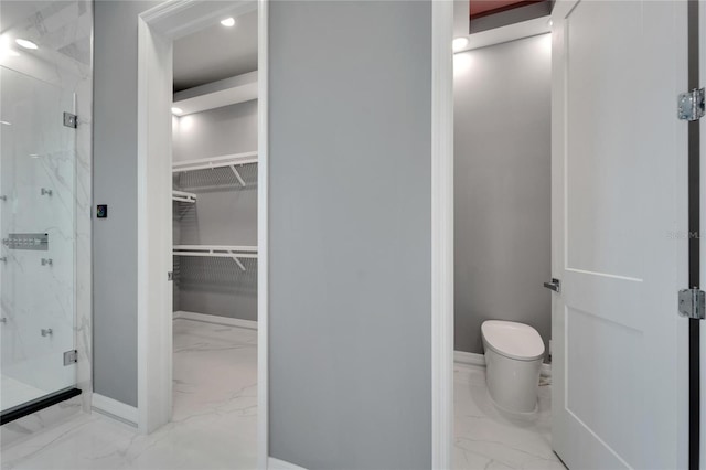 bathroom with an enclosed shower, toilet, and tile flooring