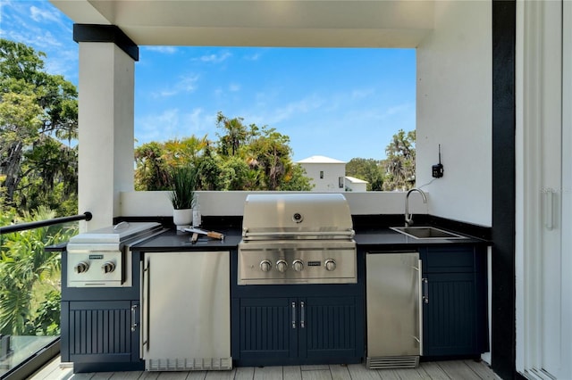 view of terrace with area for grilling, sink, and an outdoor kitchen