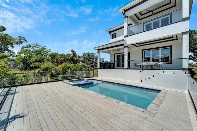 view of pool featuring a wooden deck and an in ground hot tub