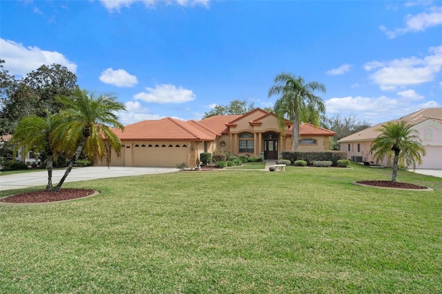 mediterranean / spanish home with a front lawn and a garage