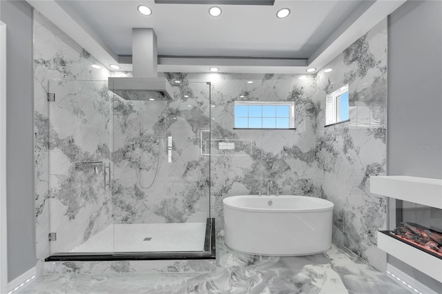 bathroom featuring tile walls, tile flooring, and independent shower and bath