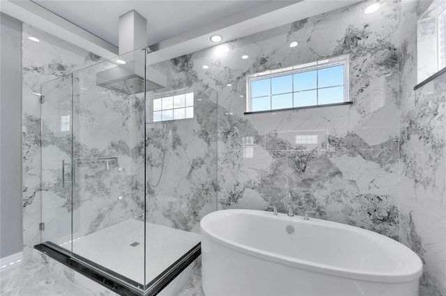 bathroom with tile walls, tile flooring, and separate shower and tub