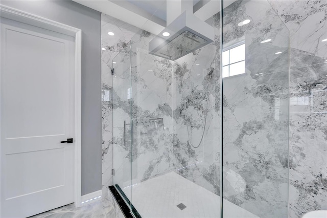 bathroom with a shower with shower door and tile flooring