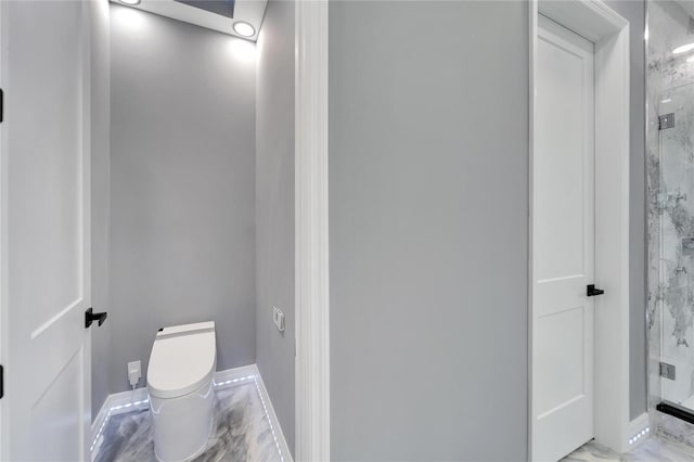 bathroom with a shower with shower door, tile flooring, and toilet